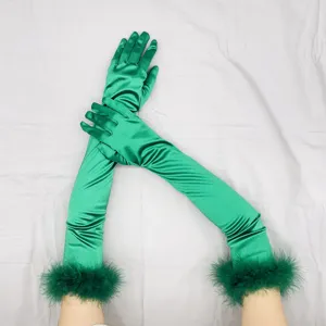 Detail view of long green satin gloves with fluffy feather cuffs, vintage 1920s party style.