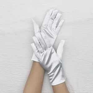 Detail shot of white stretch satin gloves, smooth glossy fabric texture, elegant hand display.