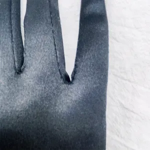Long satin gloves detail view, classic 1920s vintage opera costume party accessory.