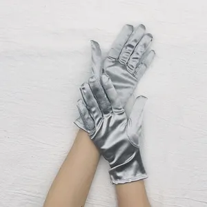 Short stretch satin silver gloves for ballroom performance and evening dress details.