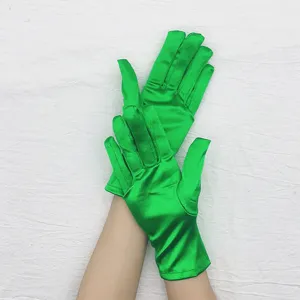 Green satin short gloves detail view, smooth shiny fabric texture for evening dress.