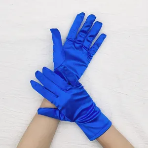 Detail view of royal blue short stretch satin gloves, elegant shiny finish for evening party.
