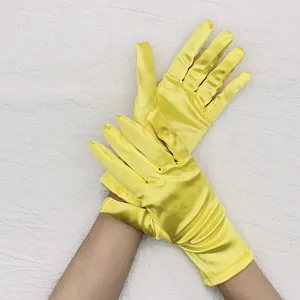 Detailed view of short stretch satin yellow gloves for ballroom dance, party, and formal events.