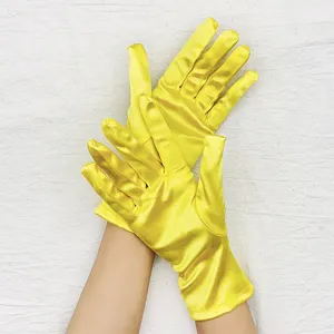 Close-up detail of yellow satin stretch short gloves, smooth fabric texture for evening events.
