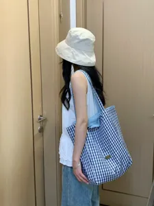 Stylish blue and white plaid canvas tote bag for women, perfect for daily commuting and shopping.