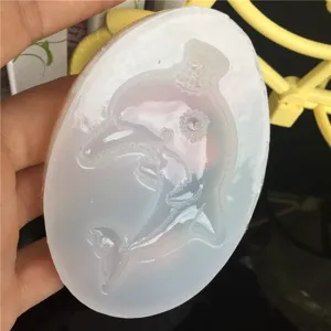 Silicone mold for DIY crystal epoxy resin, featuring an oval ocean dolphin design for crafts.