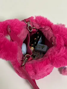 Fluffy plush bucket bag interior detail showing large capacity, soft pink furry handbag.
