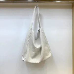 Detail view of the casual herringbone textured fabric shoulder tote bag, soft slouchy hobo style.