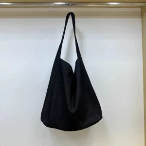 Detailed view of the casual black slouchy shoulder tote bag showing spacious design and soft fabric.