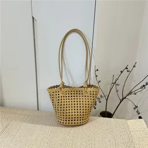 Woven bucket bag detail showing intricate lattice pattern and knotted handles in beige.