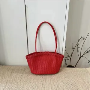 Detailed view of red woven leather shoulder tote bag, stylish daily commuting accessory style.