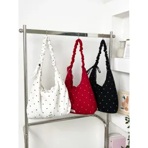 Detail shot of sweet chiffon shoulder bags featuring gathered scrunchie straps and cute polka dots.