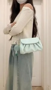 Light green cloud pleated shoulder bag featuring silver chain strap and cute plush ball charm.