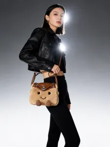 Cute plush doll shoulder bag with funny cartoon face design, soft furry crossbody bag.