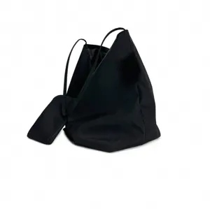 Detailed view of the black minimalist soft shoulder bag, stylish commuter triangular design.