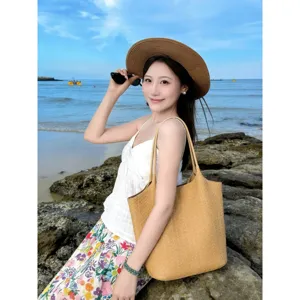 Detailed shot of the woven tote bag, elegant beach vacation style, large capacity, chic design.