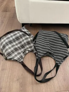 Detail view of casual canvas shoulder bags with plaid and striped patterns for daily commute.