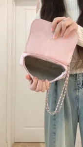 Pink chain shoulder bag for women, stylish underarm crossbody bag with flap and metal strap.