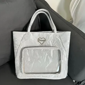 Clear front pocket tote bag with heart metal plaque and water ripple texture design.