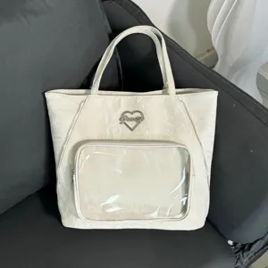 Large capacity white crinkle tote bag with clear front pocket and heart logo detail for daily use.