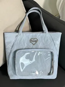 Light blue crinkled tote bag with clear front pocket and metal heart logo daily use.