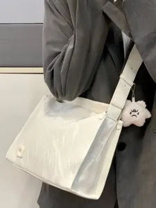 Stylish white large capacity crossbody shoulder bag detail with wide strap and cute charm.