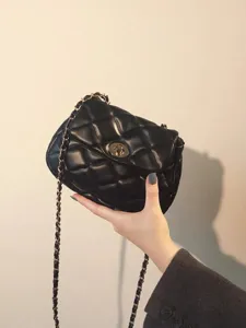 Black quilted chain shoulder bag detail shot, classic luxury design, versatile everyday accessory.