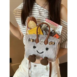 Cute cartoon smile plush handbag for women, soft grey shoulder bag with cute feet design.