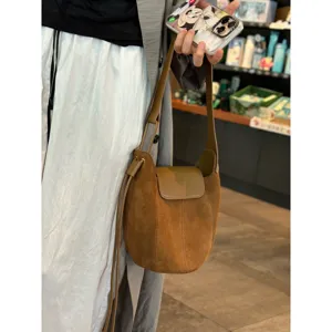 Vue détaillée du sac seau en daim rétro, sac à épaule en cuir souple au design chic.