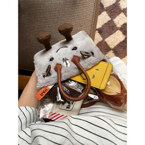 Cute plush crossbody bag, fluffy winter messenger bag with funny cartoon face and top handle.