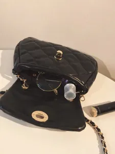 Detailed close-up showing interior and hardware features of the stylish black quilted bag.