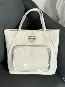 White clear front pocket ita tote bag with heart logo for daily use and anime pins display.