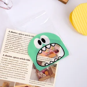 Close-up detail of cute monster self-adhesive plastic packaging bag with insert card.