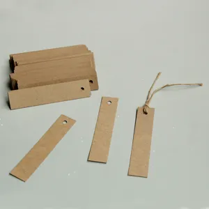 Detail view of blank kraft paper hang tags with twine strings, ideal for DIY clothing bookmarks.