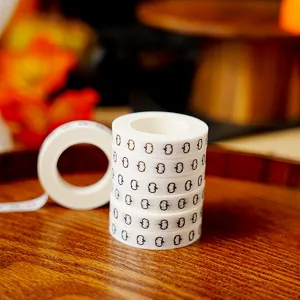 Halloween black pumpkin pattern washi tape detail view, decorative adhesive tape for journal crafts.