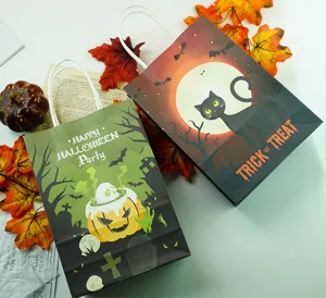 Detail view of Halloween gift paper bags with cute pumpkin and black cat designs, candy bags.