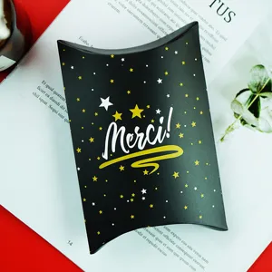 Black gold pillow gift box detail showcasing elegant star pattern and Merci text for candy packaging.