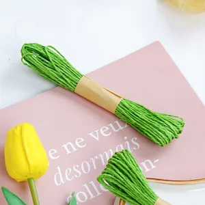Detailed close-up shot of green handmade paper twine string for gift packaging and DIY crafts.