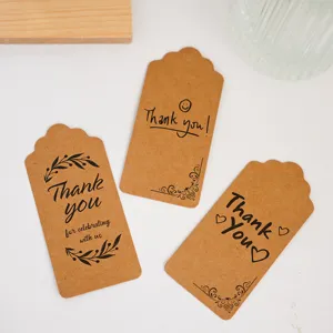 Close up of vintage kraft paper thank you hang tags with lovely print designs and details.