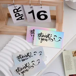 Close-up detail of holographic thank you cards with rainbow shine and cute smiley face.