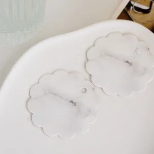 Marble pattern scalloped edge message cards and hanging tags detail closeup view on tray.