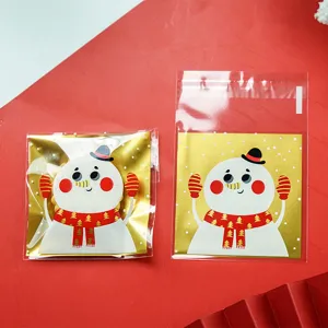 Christmas gold snowman self-adhesive cookie packaging bags detail view showing clear plastic design.