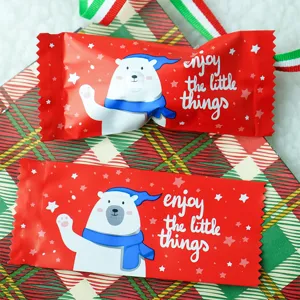 Detailed close-up view of Christmas polar bear nougat candy packaging bags with festive red design.