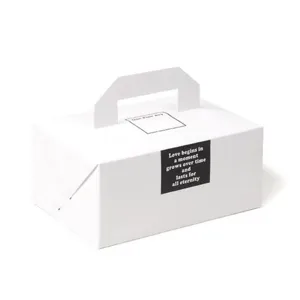 Boîte de transport en papier blanc pour boulangerie, biscuits et gâteaux avec poignée et texte.