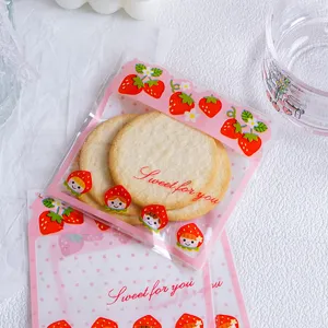 Cute strawberry cartoon self-adhesive cookie and candy packaging gift bags for party favors.