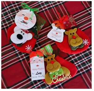 Close-up of Christmas treat bags with plush deer, polar bear, and customized holiday tags.