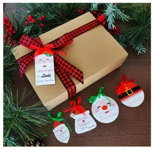 Close-up detail of Christmas gift tags with cute Santa designs and plaid ribbon decoration.