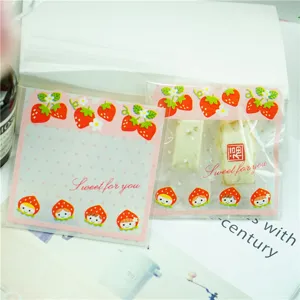 Cute strawberry cartoon self-adhesive candy packaging bags for gift wrapping and party favors.