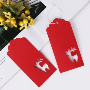 Detailed view of red paper Christmas hang tags with hollow reindeer design for holiday DIY craft.