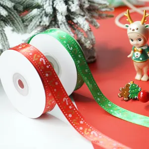 Nahaufnahme von Weihnachtsband-Rollen mit festlichen roten und grünen Zuckerstangen.